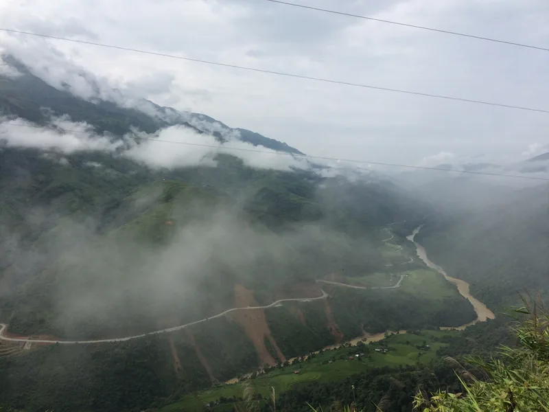 Mist drifts over a winding mountain river valley near Sin Ho in Lai Chau province, Vietnam.